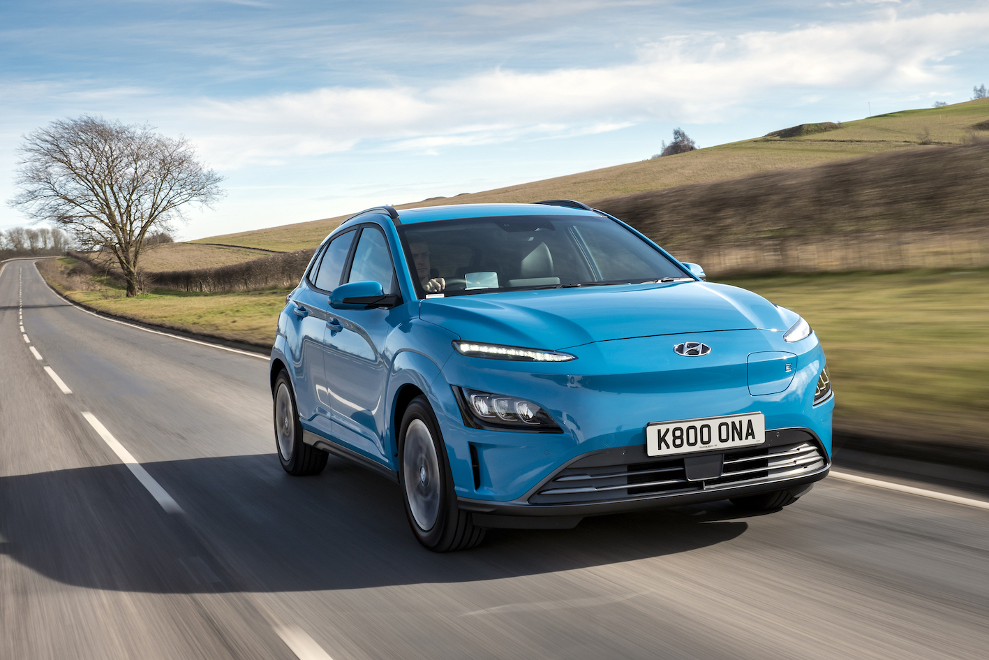 Hyundai Kona electric car driving through countryside